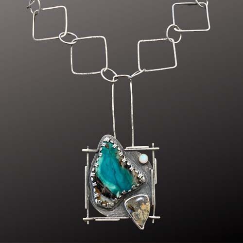 Metal necklace with squares and teal stone